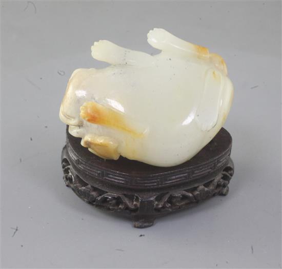 An unusual Chinese pale celadon and russet skin jade lion-dog snuff bottle, 19th century, length 5cm excl. wood stand